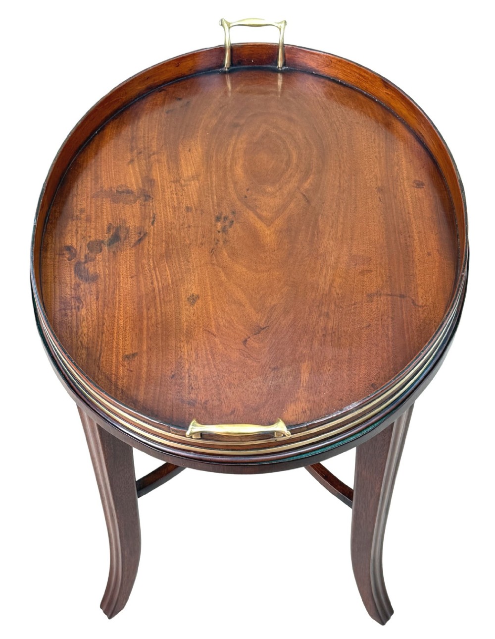 A Georgian mahogany oval tray table featuring a double brass-bound gallery rim, twin side handles, and four splayed legs joined by an X-frame stretcher. View III