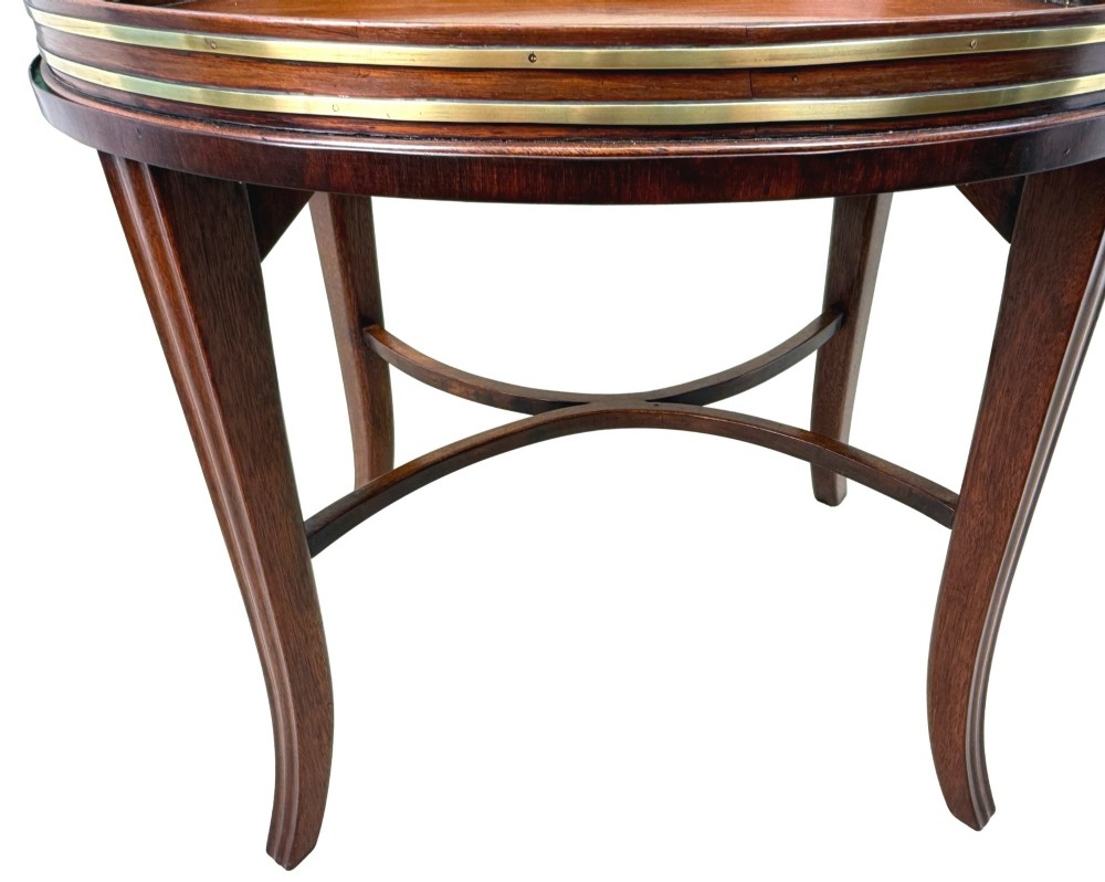 A Georgian mahogany oval tray table featuring a double brass-bound gallery rim, twin side handles, and four splayed legs joined by an X-frame stretcher. View VIII