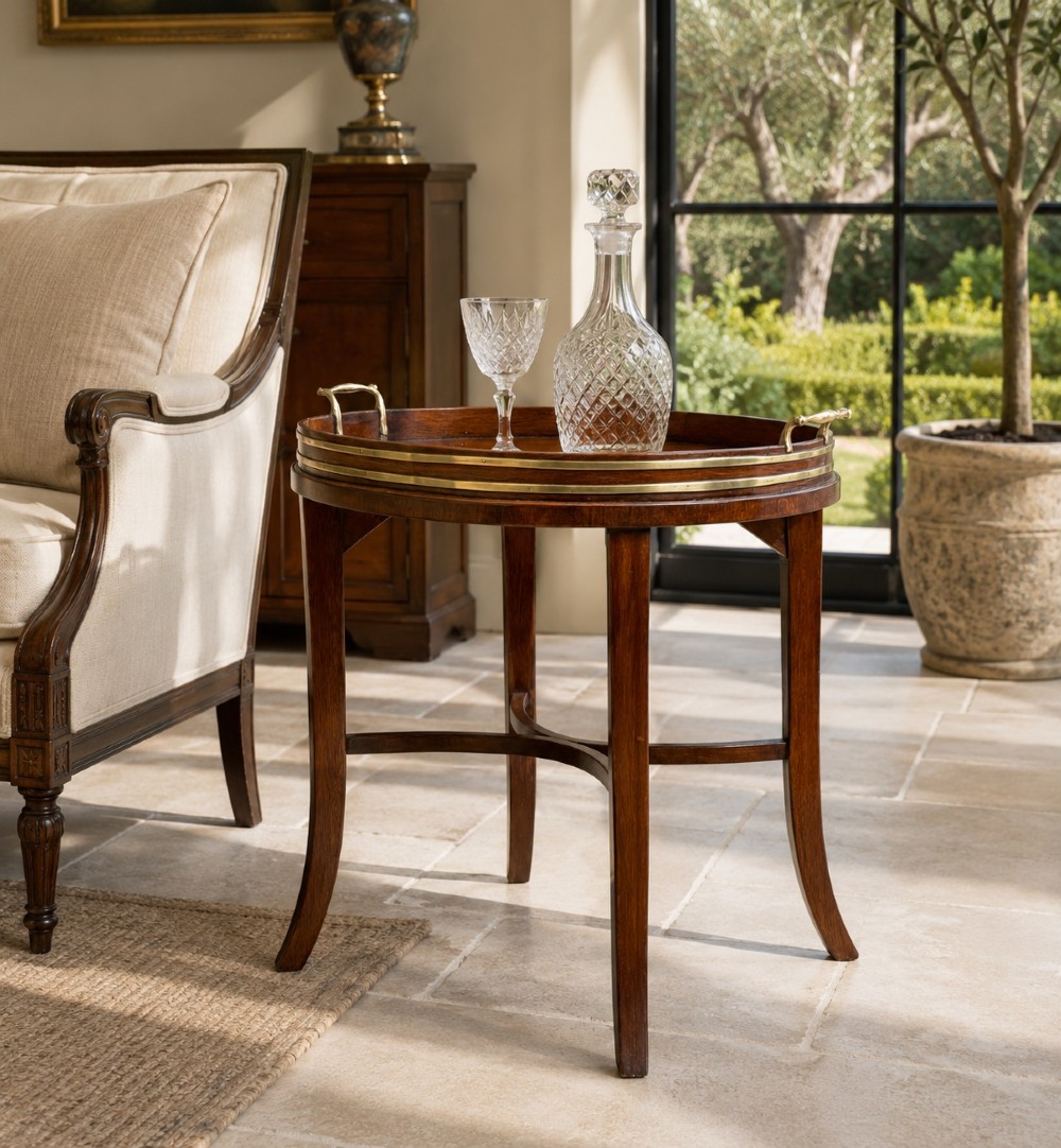 A Georgian mahogany oval tray table featuring a double brass-bound gallery rim, twin side handles, and four splayed legs joined by an X-frame stretcher. View XIII