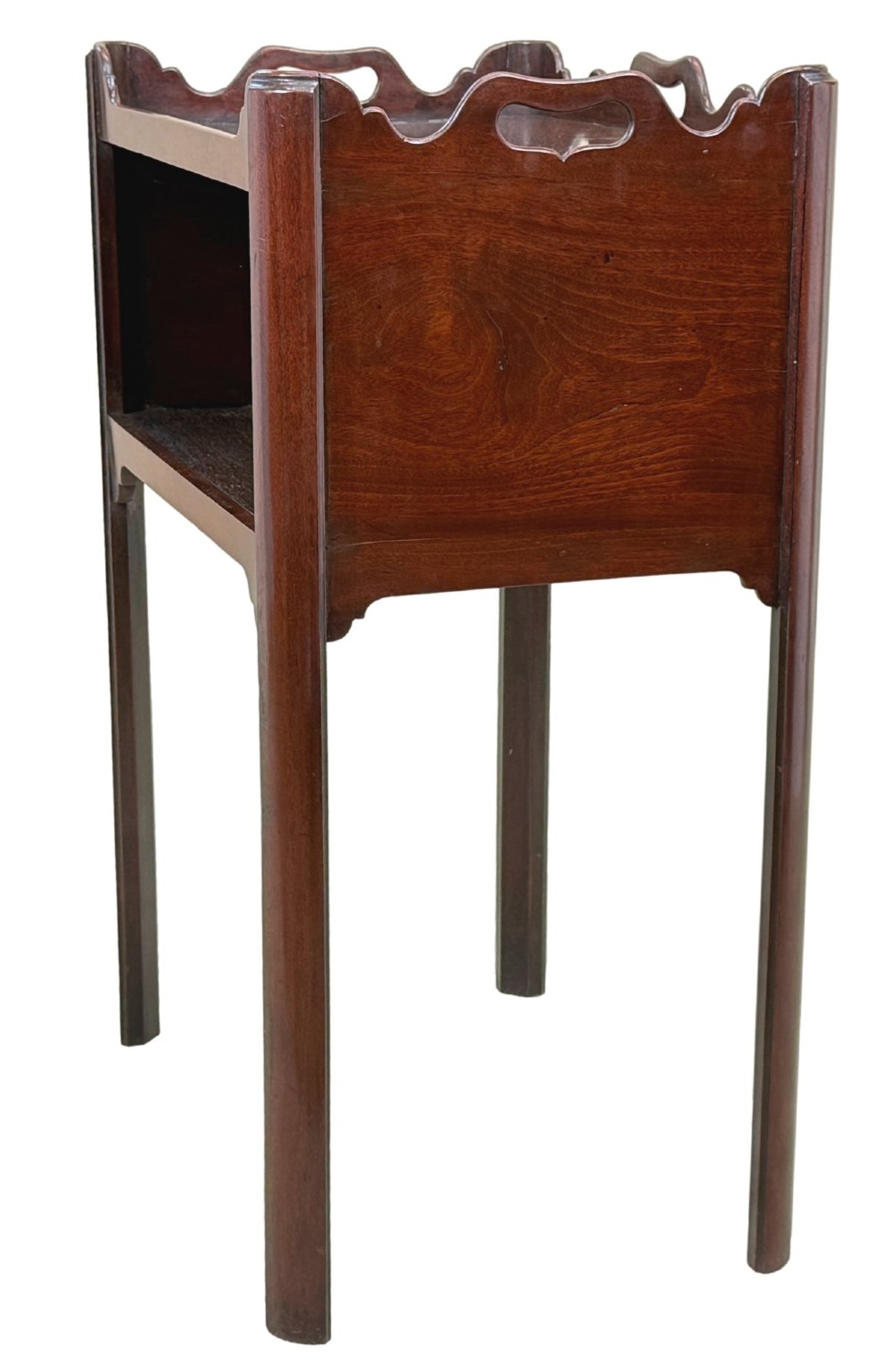 An 18th-century Georgian mahogany bedside table with a wavy gallery top featuring pierced hand cutouts, an open shelf compartment, and four square legs. View II