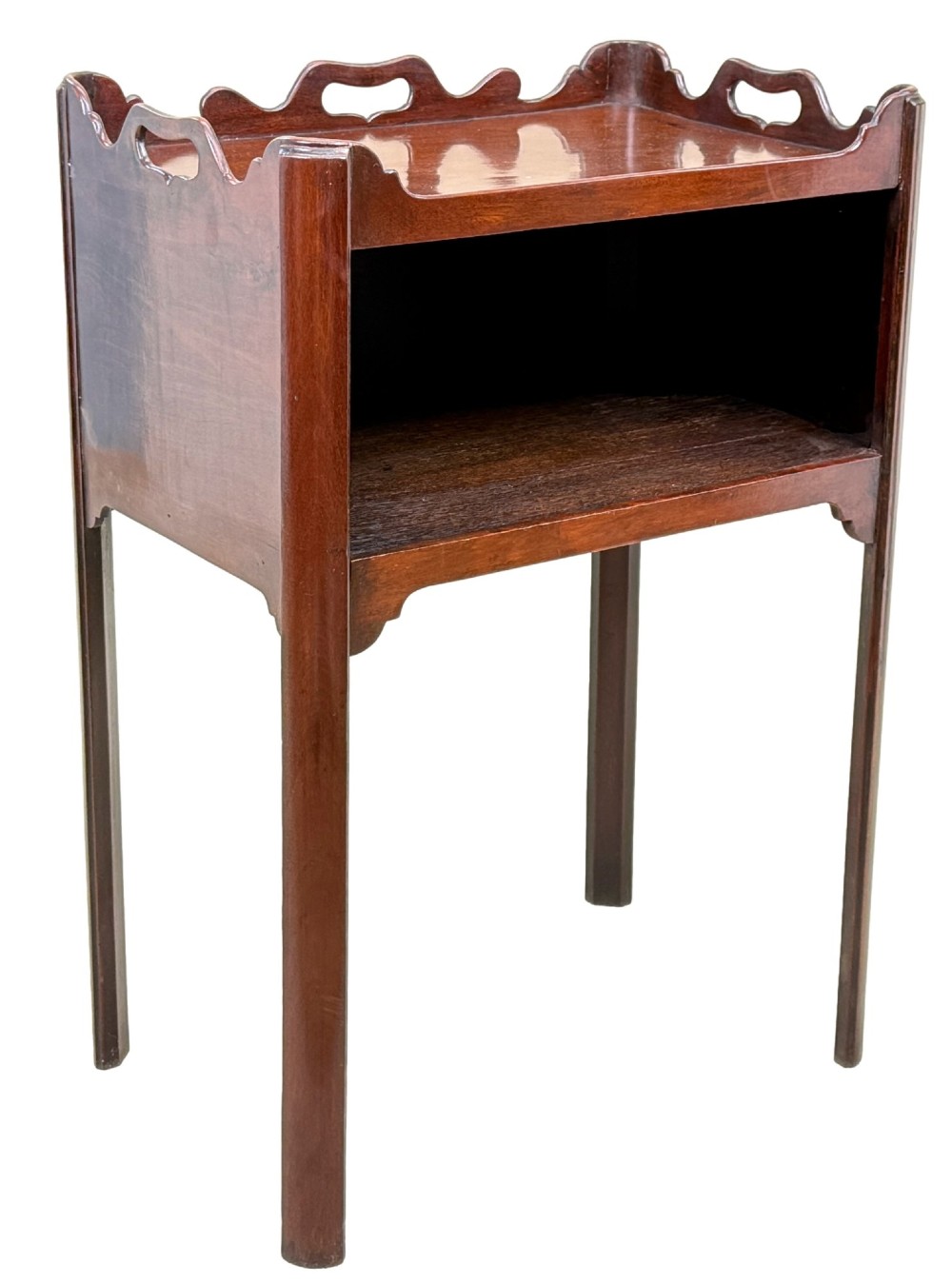 An 18th-century Georgian mahogany bedside table with a wavy gallery top featuring pierced hand cutouts, an open shelf compartment, and four square legs. View VII