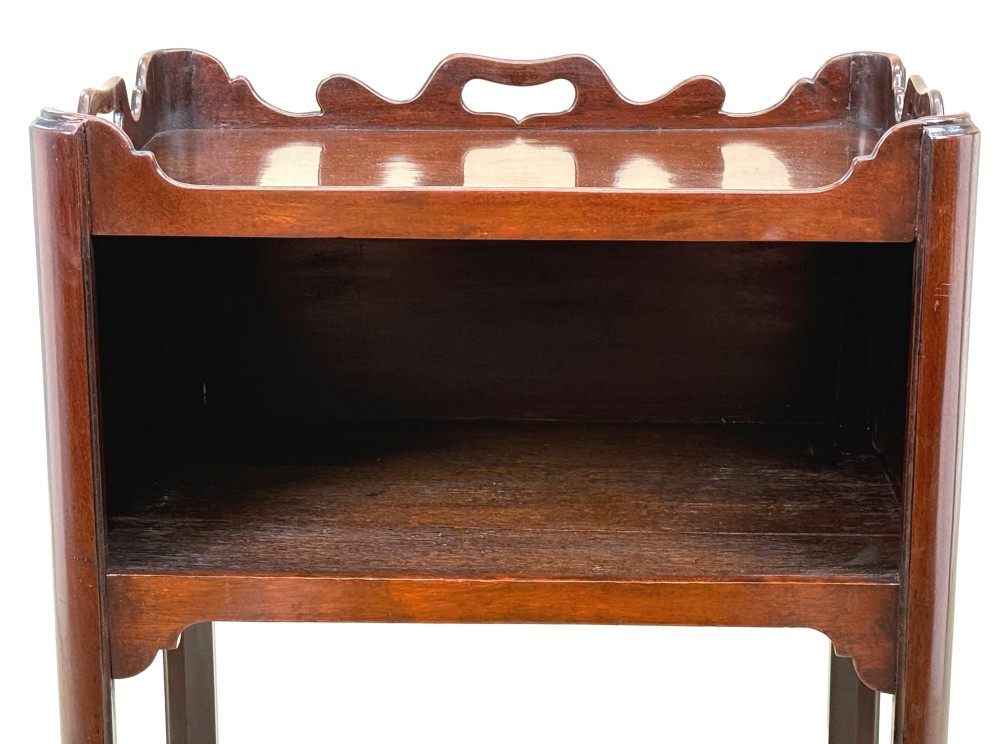 An 18th-century Georgian mahogany bedside table with a wavy gallery top featuring pierced hand cutouts, an open shelf compartment, and four square legs. View VIII