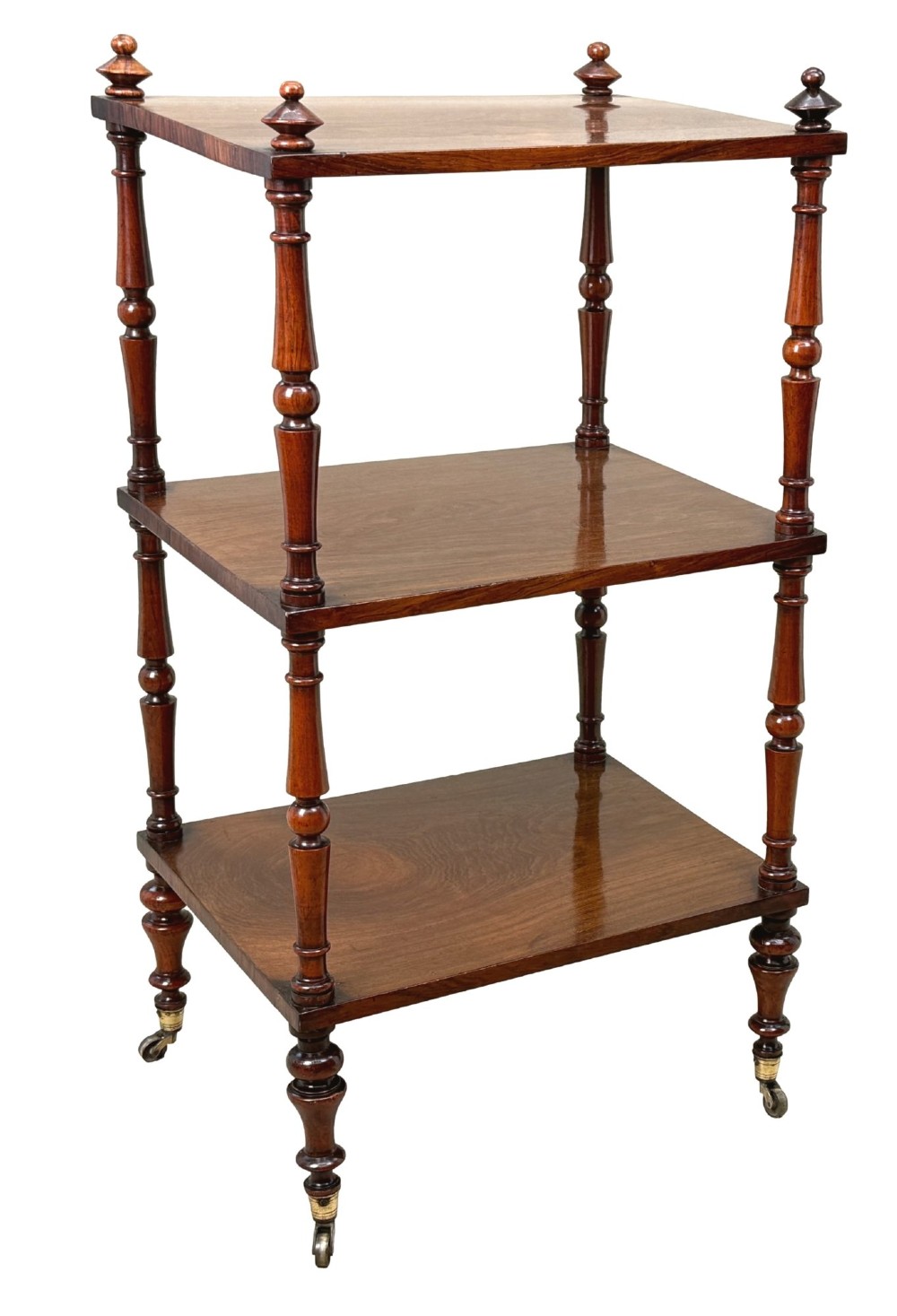 A mid-19th-century rosewood three-tier whatnot with turned spindles, finials, and brass castors. View XI