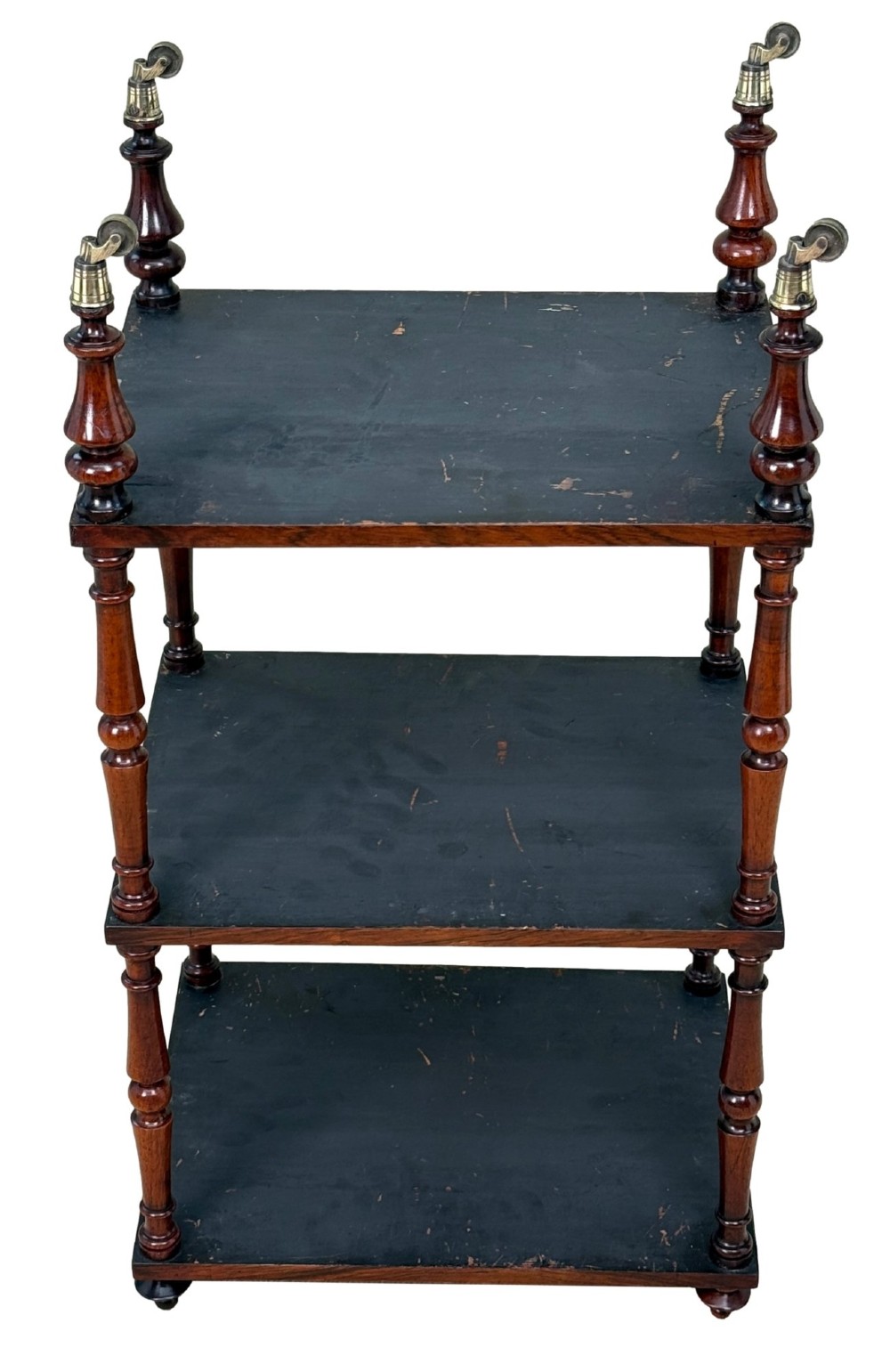 A mid-19th-century rosewood three-tier whatnot with turned spindles, finials, and brass castors. View XII