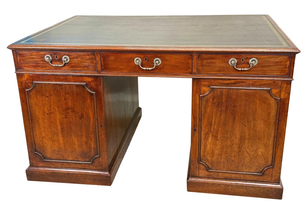 An 18th-century Georgian mahogany partners desk featuring three top frieze drawers and twin pedestal cupboards set on a plinth base. View VII