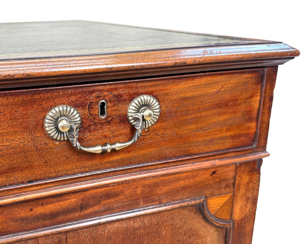 An 18th-century Georgian mahogany partners desk featuring three top frieze drawers and twin pedestal cupboards set on a plinth base. View VIII