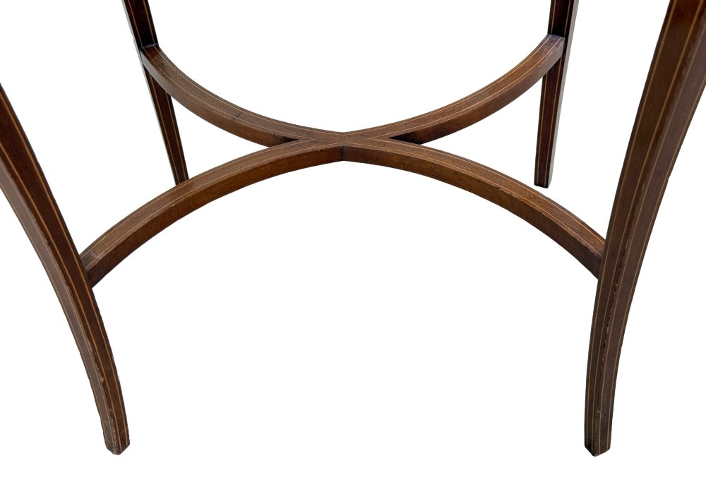 An oval late 19th-century mahogany bijouterie display table featuring glass side panels, inlaid floral marquetry, slender cabriole legs, and a cross stretcher. View XI