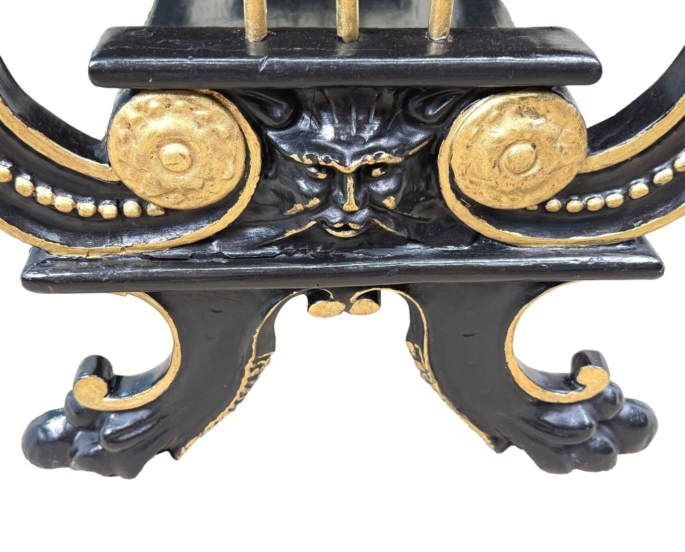 A late nineteenth-century ebonised three-tiered etagere featuring lyre-shaped side supports, gilt bead trim along the shelf edges, and carved scroll feet. View VIII