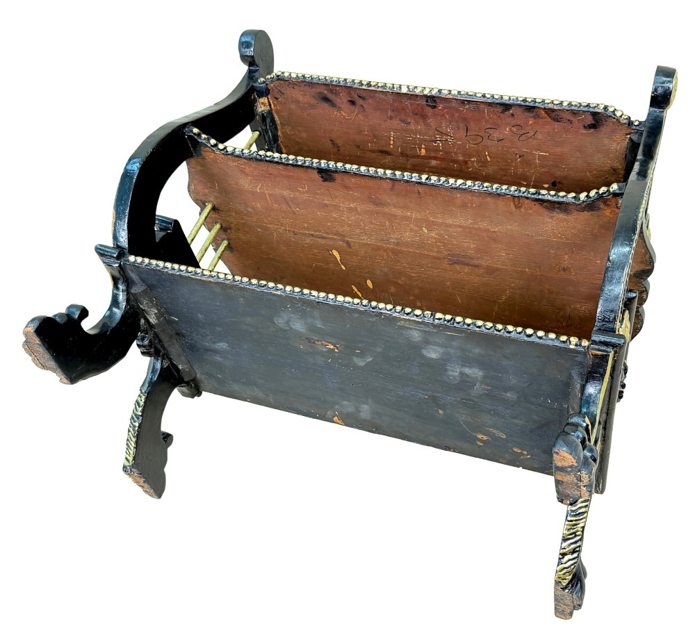 A late nineteenth-century ebonised three-tiered etagere featuring lyre-shaped side supports, gilt bead trim along the shelf edges, and carved scroll feet. View X