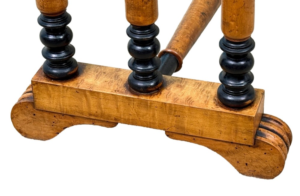 A pair of Regency birdseye maple occasional tables featuring quadrupled slender turned legs with ebonised details and a stretcher base. View V