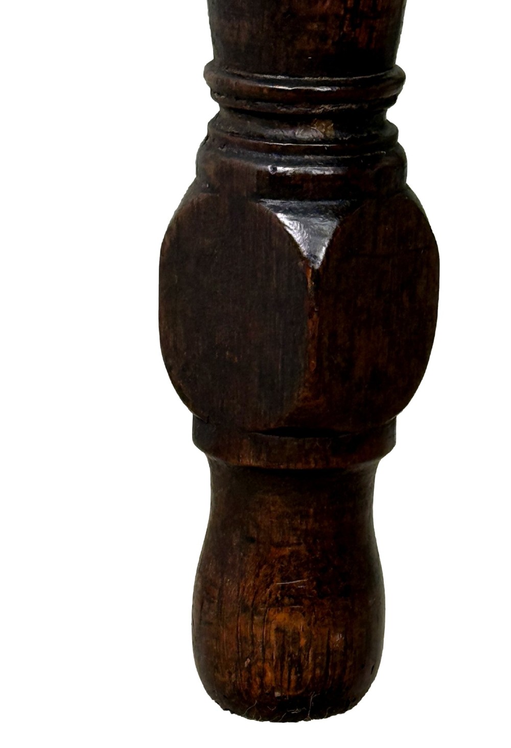 An early eighteenth-century oak dresser base featuring three drawers with brass drop handles, brass keyhole escutcheons, turned front legs, and a dark brown finish. View VII
