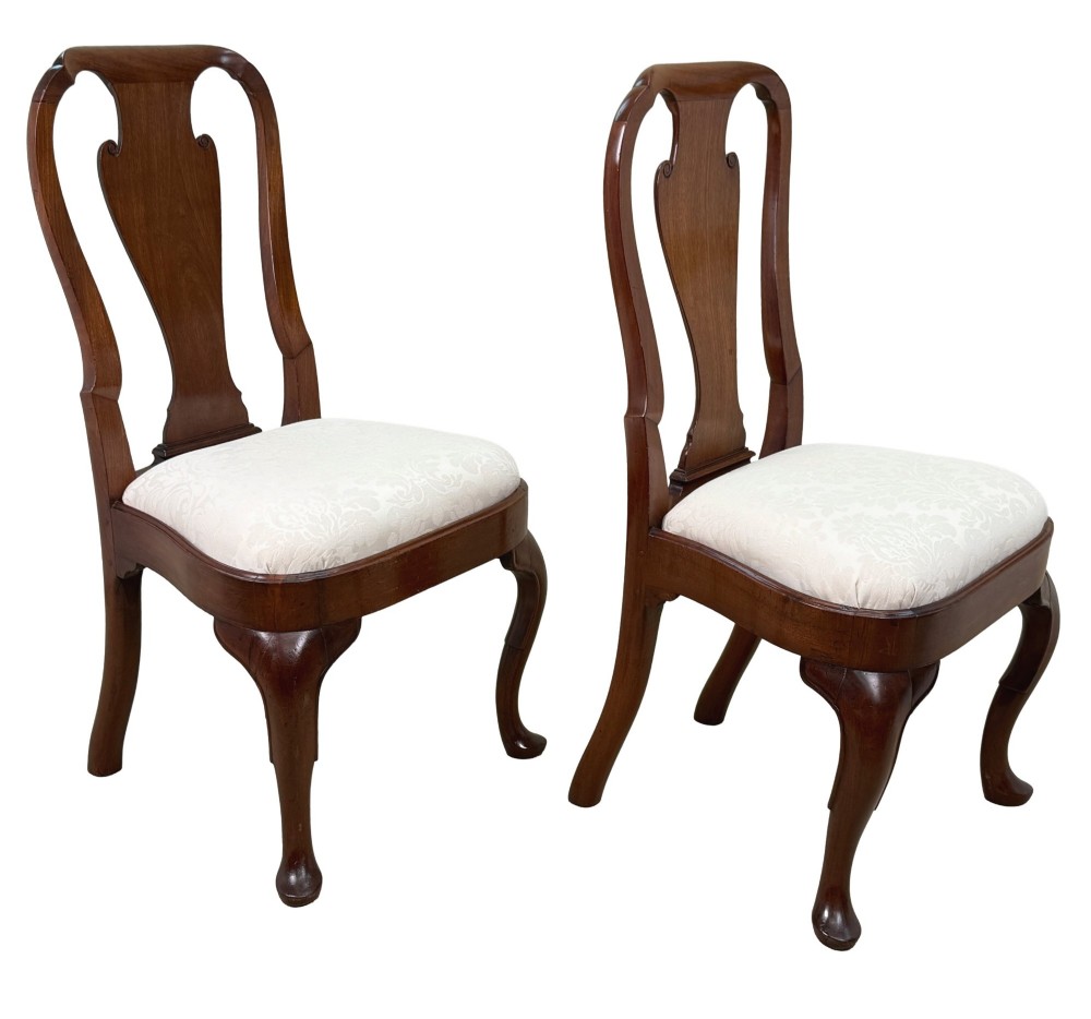 A pair of early 18th-century Queen Anne walnut side chairs featuring vase-shaped back splats, curved cabriole front legs, and cream upholstered drop-in seats. View II