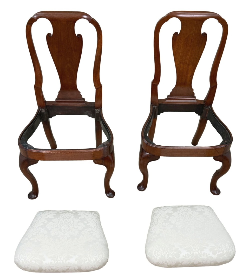 A pair of early 18th-century Queen Anne walnut side chairs featuring vase-shaped back splats, curved cabriole front legs, and cream upholstered drop-in seats. View XI
