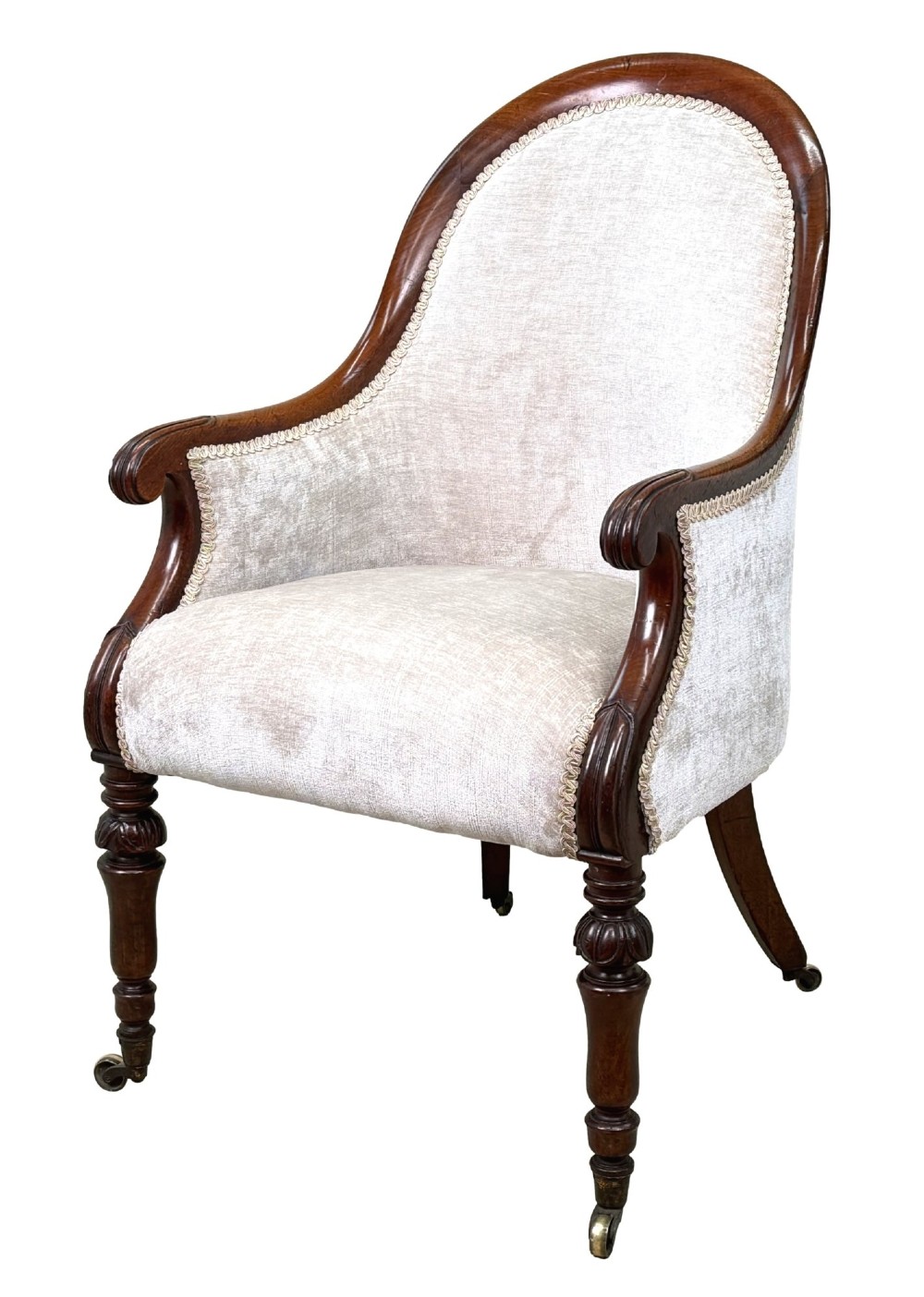 A 19th-century English Regency mahogany tub armchair with cream upholstery, scrolled armrests, turned legs, and brass castors.