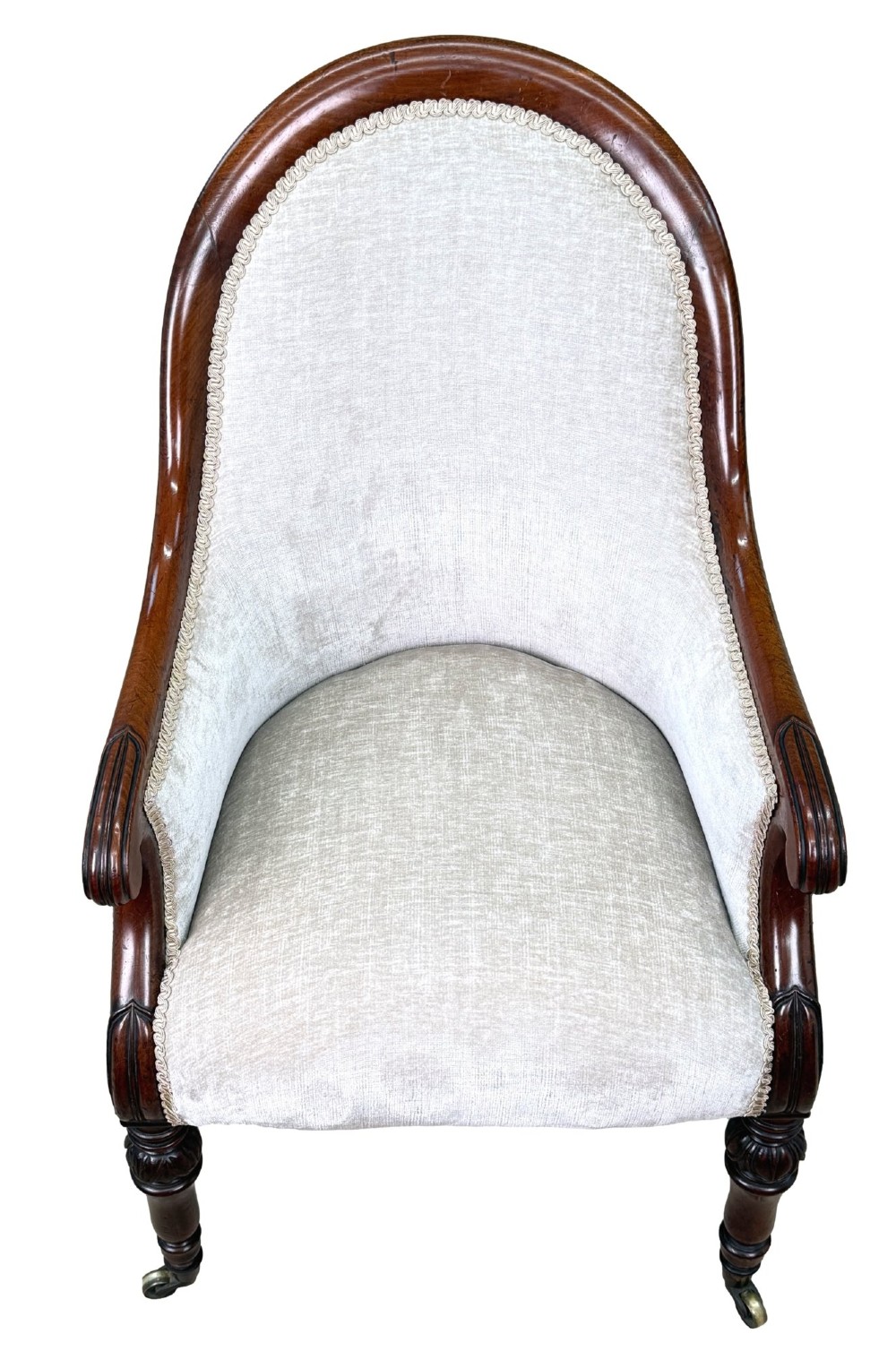 A 19th-century English Regency mahogany tub armchair with cream upholstery, scrolled armrests, turned legs, and brass castors. View VI