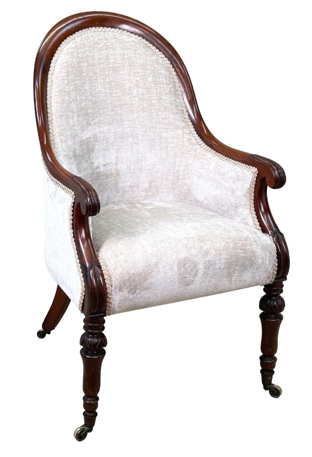 A 19th-century English Regency mahogany tub armchair with cream upholstery, scrolled armrests, turned legs, and brass castors. View VIII