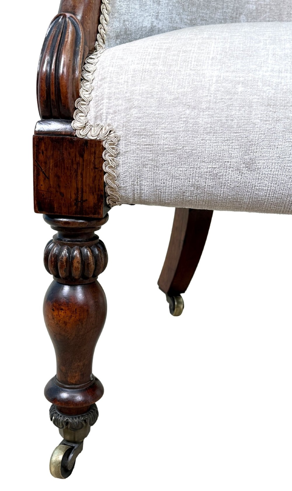 A 19th-century Regency period rosewood tub library armchair upholstered in cream fabric with turned legs and brass castors. View IX