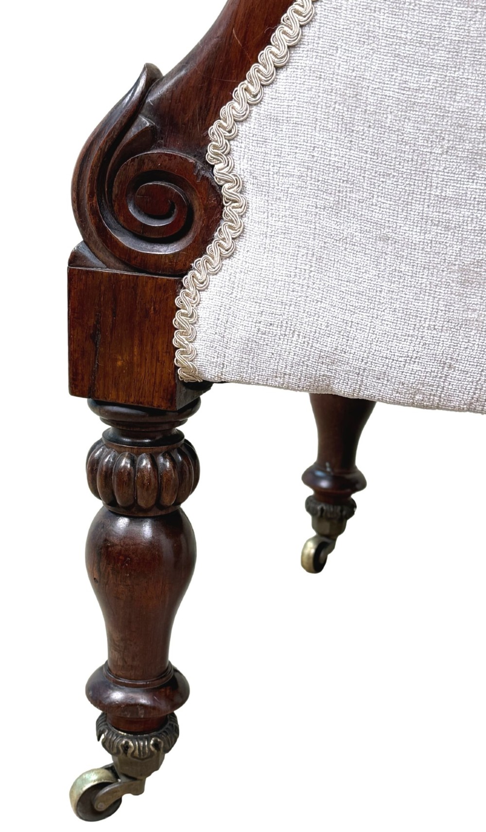 A 19th-century Regency period rosewood tub library armchair upholstered in cream fabric with turned legs and brass castors. View XI