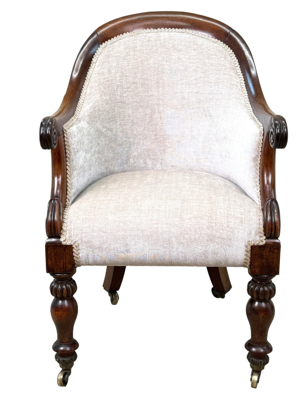 A 19th-century Regency period rosewood tub library armchair upholstered in cream fabric with turned legs and brass castors. View XV