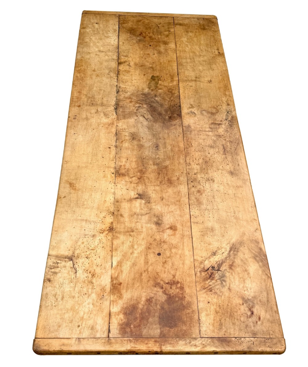 An early 19th-century French Provincial sycamore farmhouse dining table featuring a light wood plank top and tapered square legs. View VI