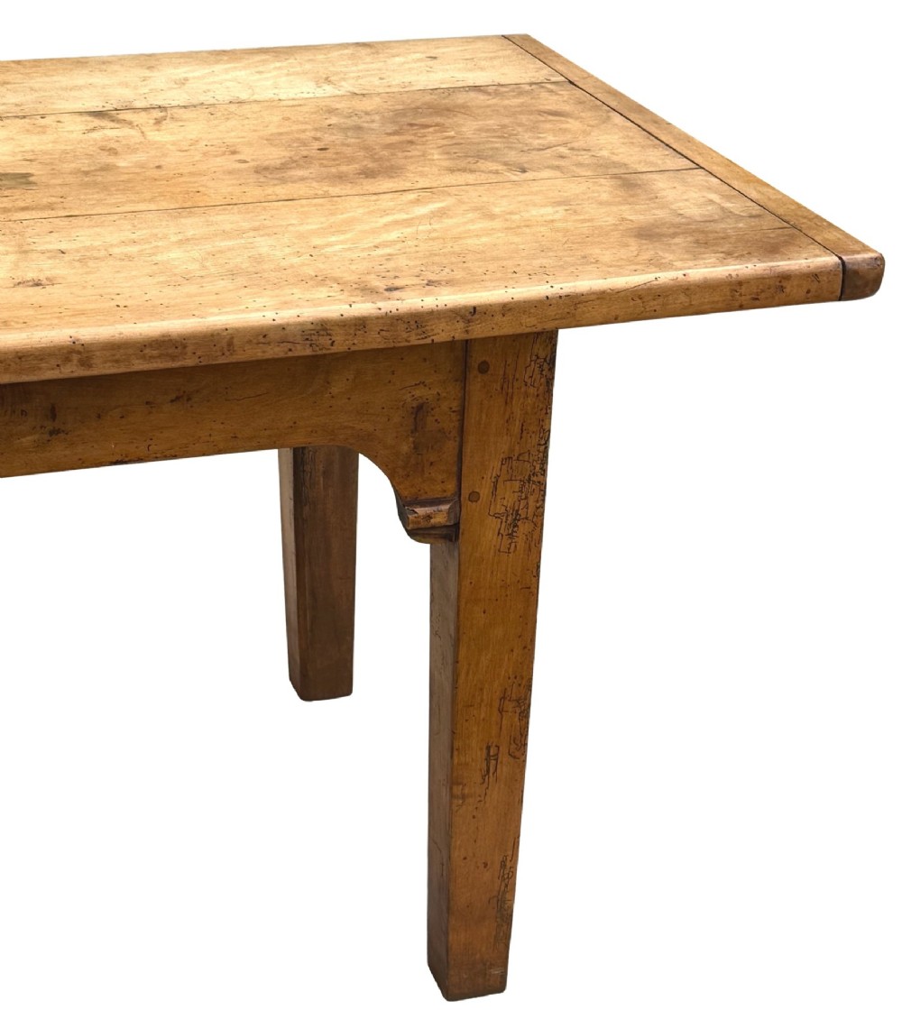 An early 19th-century French Provincial sycamore farmhouse dining table featuring a light wood plank top and tapered square legs. View XII
