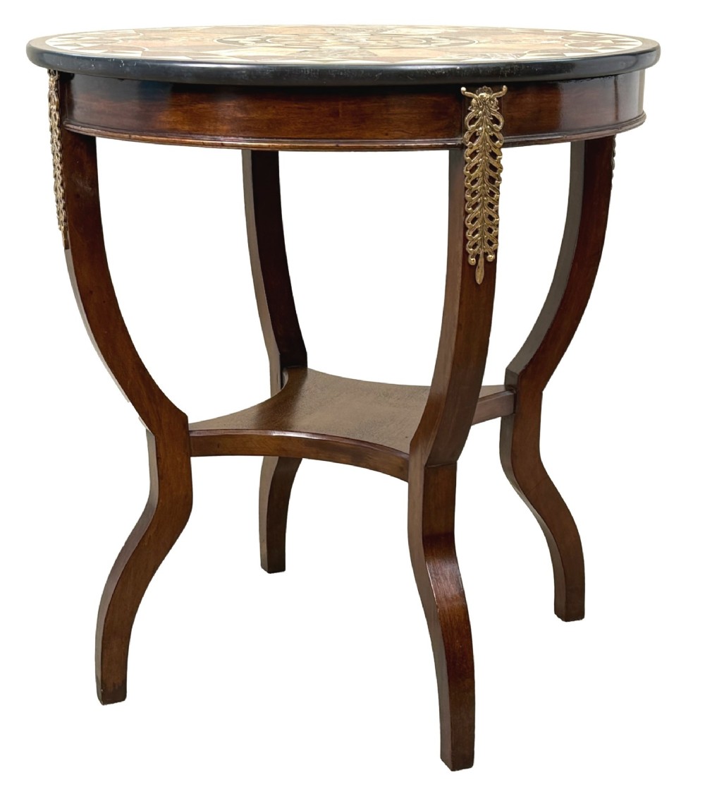 A late nineteenth-century circular mahogany occasional table featuring a specimen marble top, outcurving legs with gilt mounts, and a lower undertier.