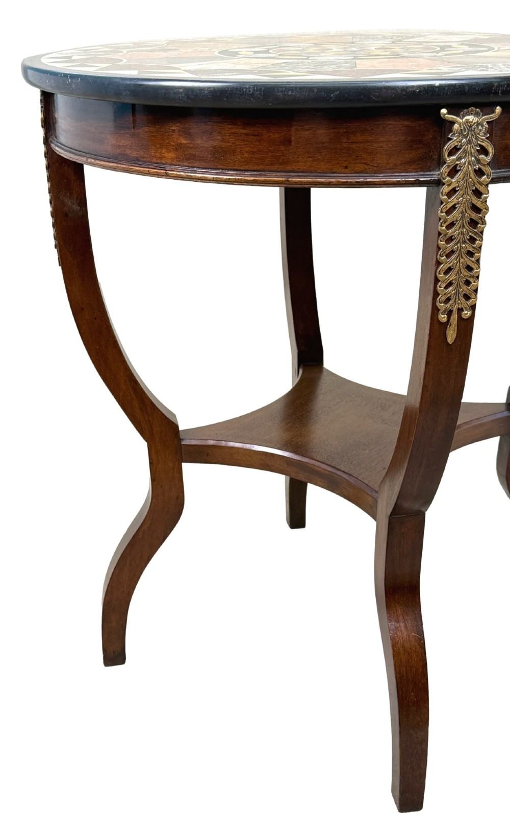 A late nineteenth-century circular mahogany occasional table featuring a specimen marble top, outcurving legs with gilt mounts, and a lower undertier. View IV