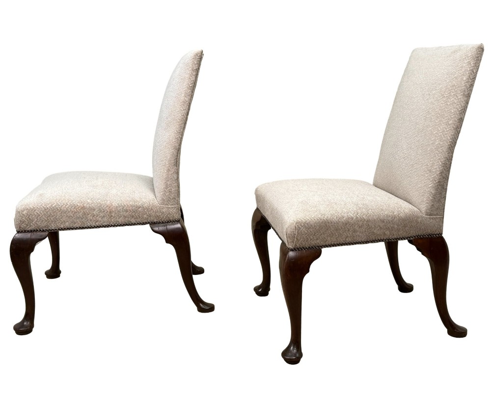A pair of Georgian walnut side chairs featuring cream textured upholstery and carved cabriole legs ending in pad feet. View II