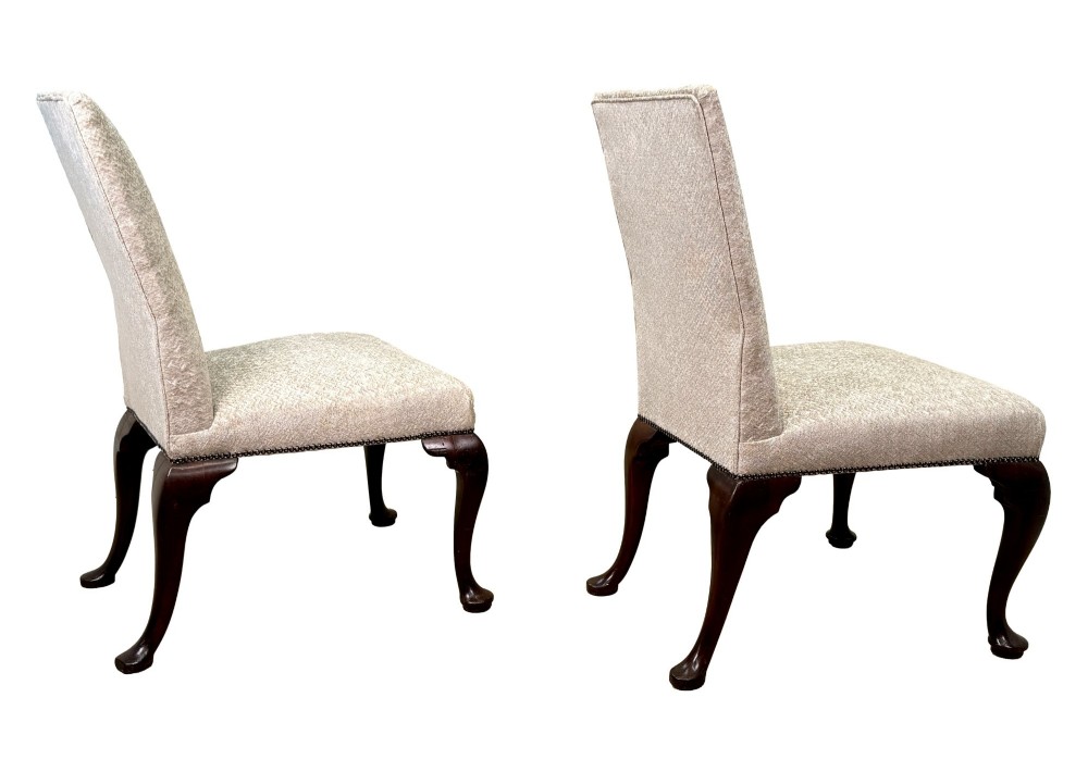 A pair of Georgian walnut side chairs featuring cream textured upholstery and carved cabriole legs ending in pad feet. View V