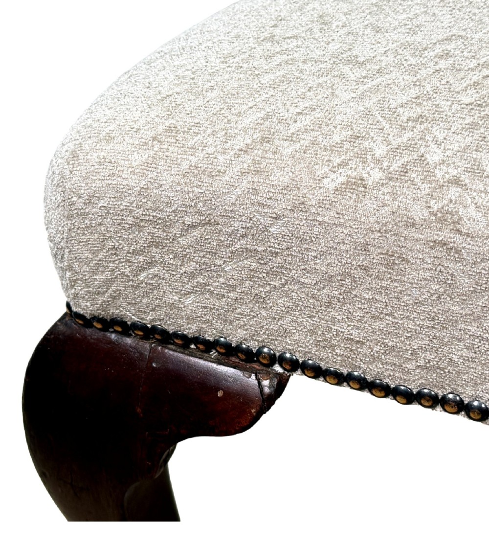 A pair of Georgian walnut side chairs featuring cream textured upholstery and carved cabriole legs ending in pad feet. View VI