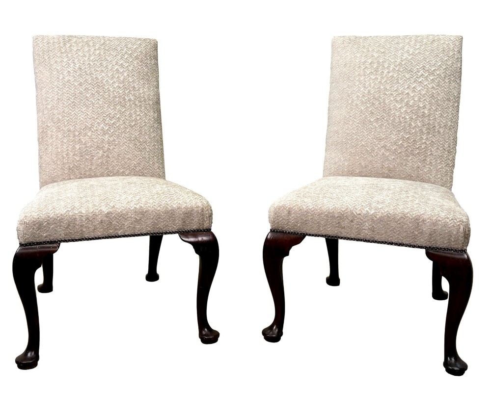 A pair of Georgian walnut side chairs featuring cream textured upholstery and carved cabriole legs ending in pad feet. View XI
