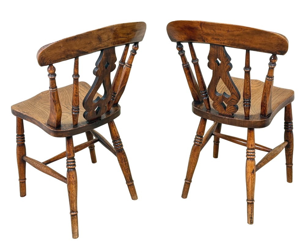 A set of six Victorian wooden Windsor dining chairs featuring shaped crest rails, pierced back splats, contoured saddle seats, and turned legs. View III