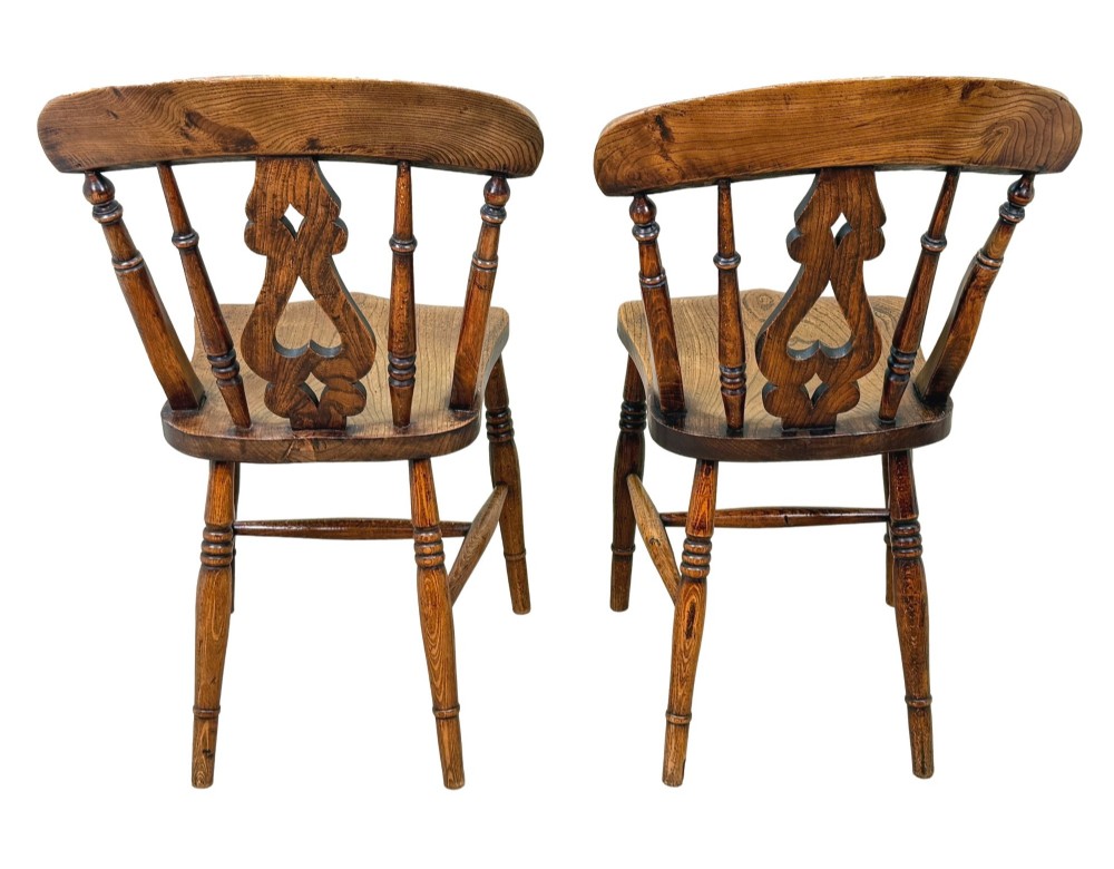 A set of six Victorian wooden Windsor dining chairs featuring shaped crest rails, pierced back splats, contoured saddle seats, and turned legs. View VII