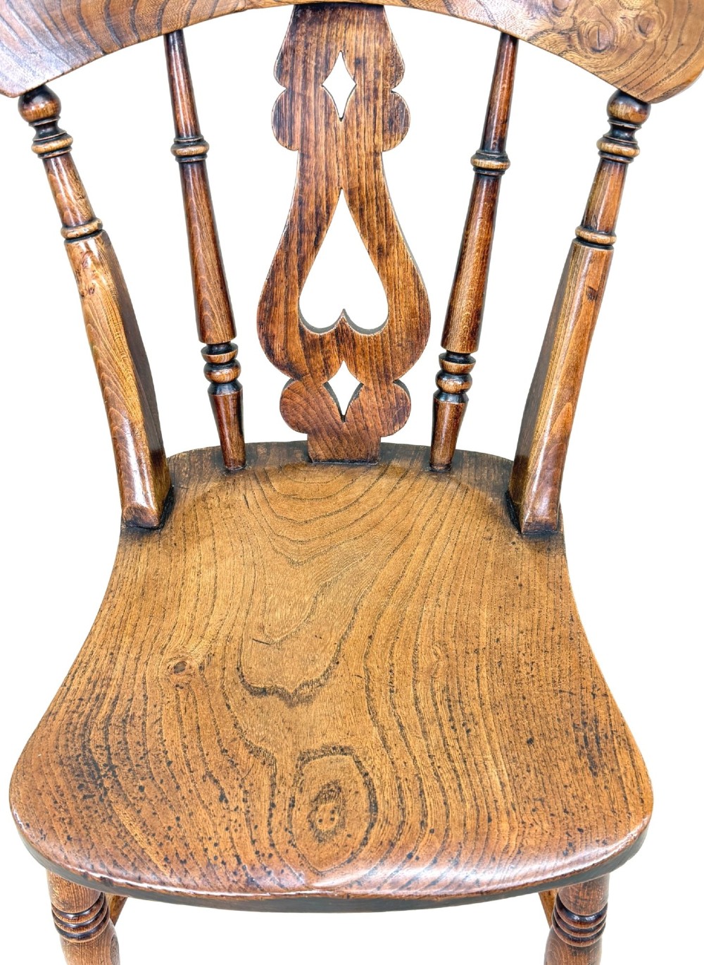 A set of six Victorian wooden Windsor dining chairs featuring shaped crest rails, pierced back splats, contoured saddle seats, and turned legs. View IX