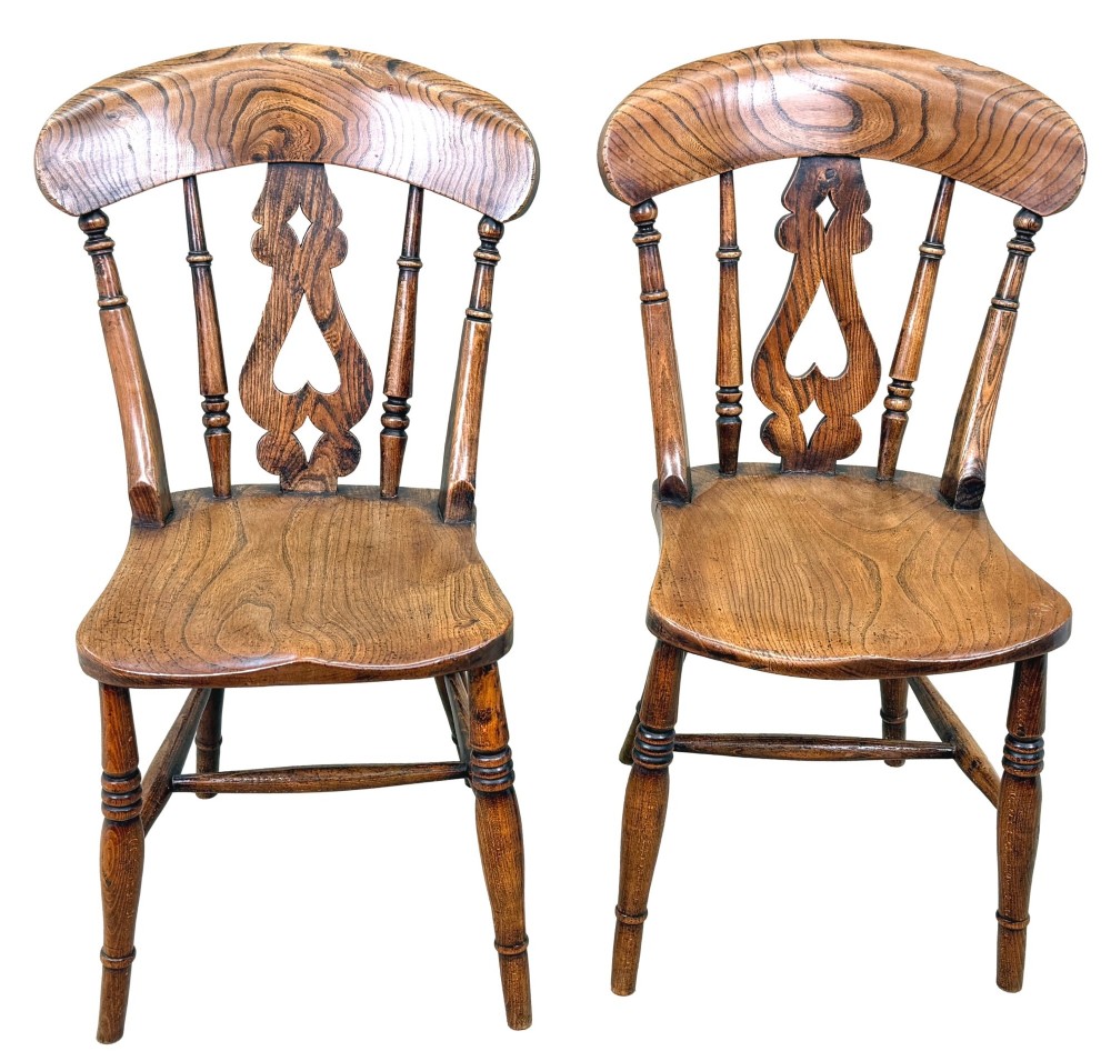 A set of six Victorian wooden Windsor dining chairs featuring shaped crest rails, pierced back splats, contoured saddle seats, and turned legs. View X