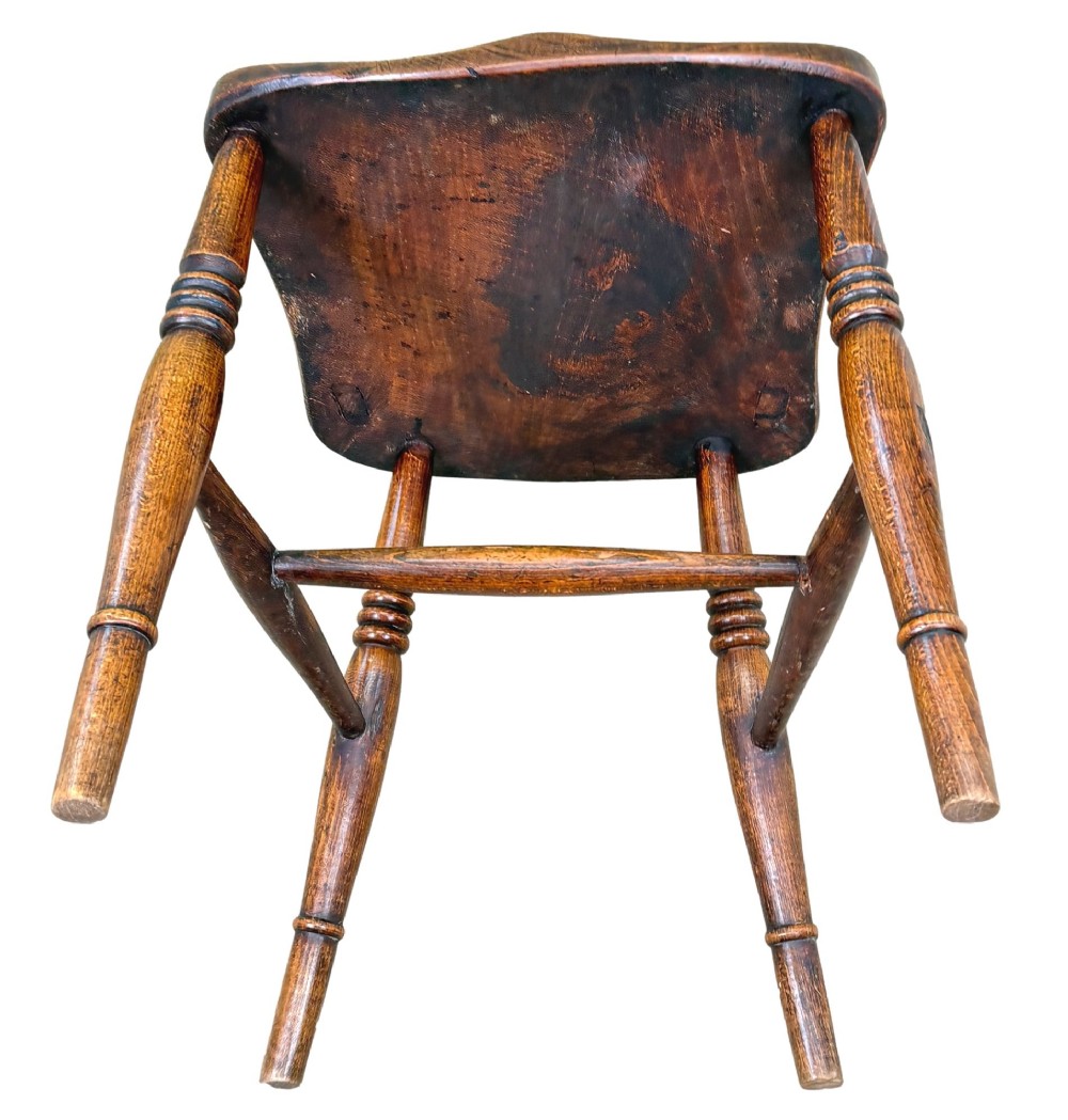 A set of six Victorian wooden Windsor dining chairs featuring shaped crest rails, pierced back splats, contoured saddle seats, and turned legs. View XII
