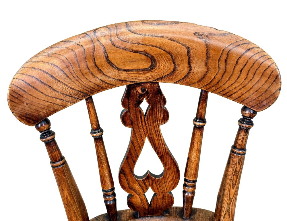 A set of six Victorian wooden Windsor dining chairs featuring shaped crest rails, pierced back splats, contoured saddle seats, and turned legs. View XIII
