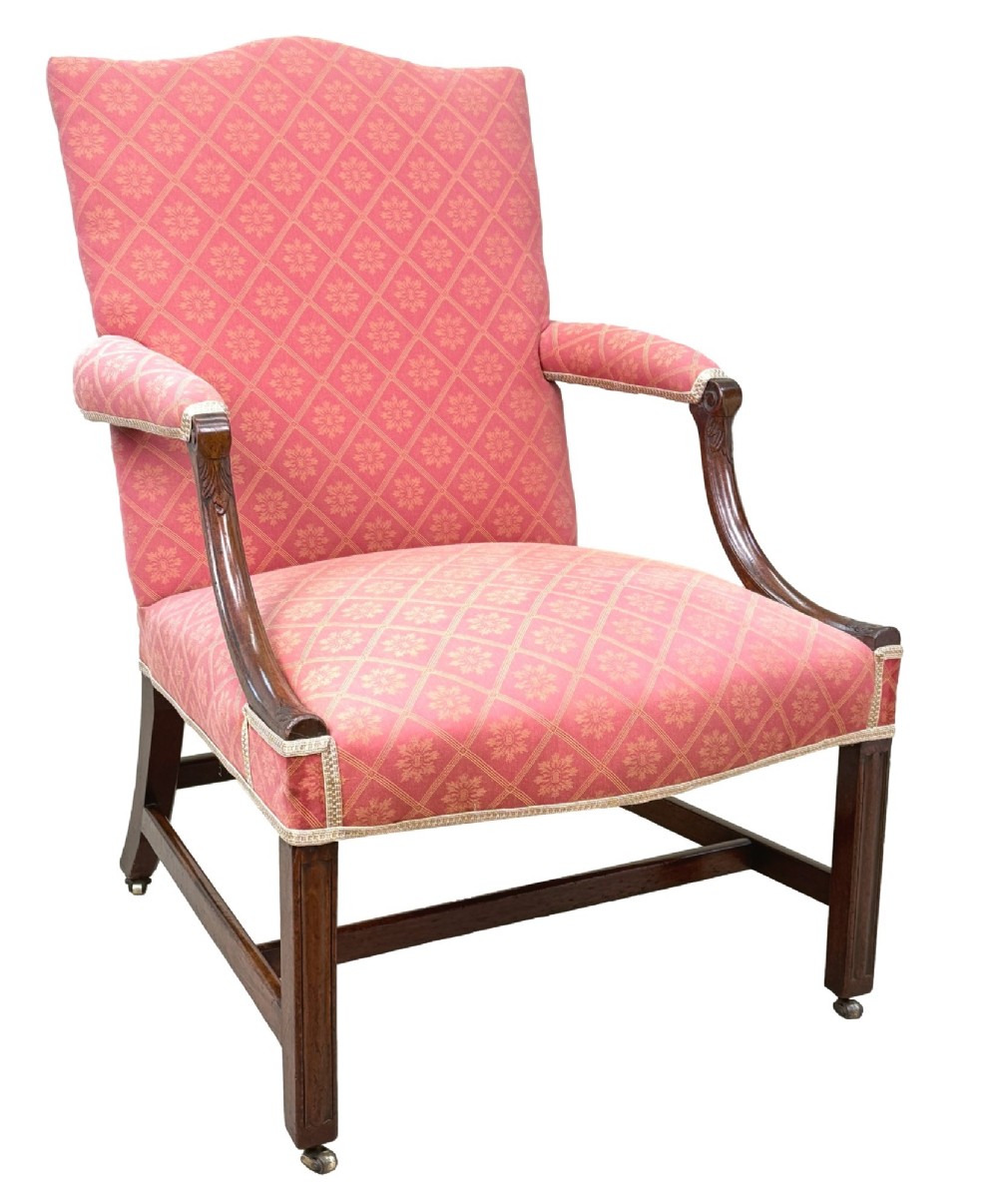 An 18th-century Georgian mahogany Gainsborough armchair with red patterned upholstery, curved carved arm supports, an H-stretcher frame, and brass castors. View VII