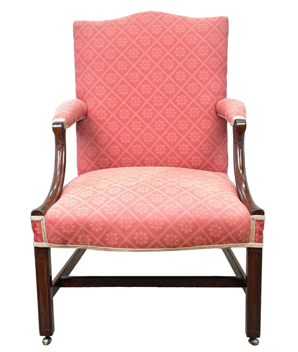An 18th-century Georgian mahogany Gainsborough armchair with red patterned upholstery, curved carved arm supports, an H-stretcher frame, and brass castors. View XIII