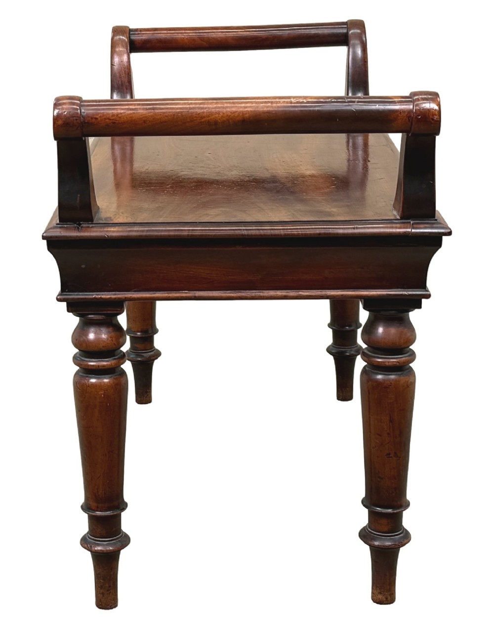 A mid-19th-century mahogany window seat with turned legs, a flat wooden seat, and curved end handles. View VI
