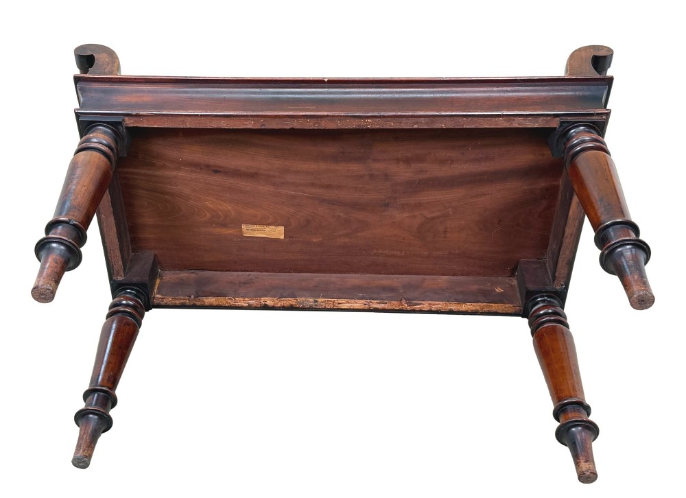 A mid-19th-century mahogany window seat with turned legs, a flat wooden seat, and curved end handles. View VIII