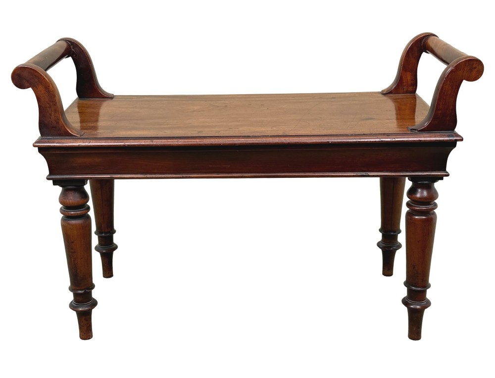 A mid-19th-century mahogany window seat with turned legs, a flat wooden seat, and curved end handles. View XI