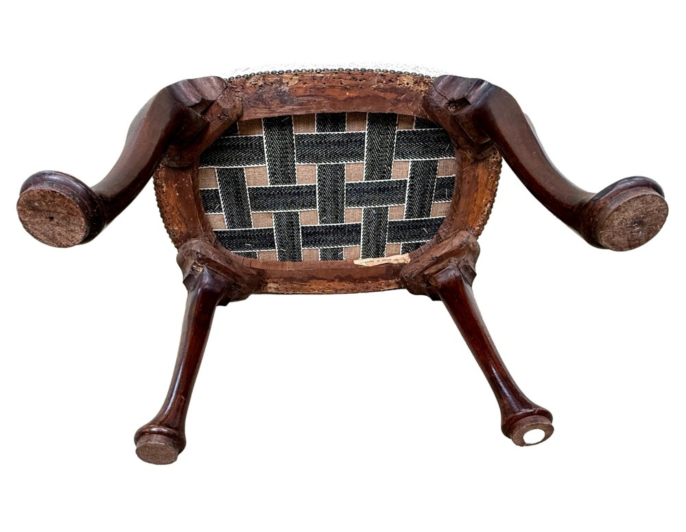 An early 18th-century George I walnut stool featuring an oval light grey upholstered seat trimmed with metal studs above four cabriole legs ending in pad feet. View IX