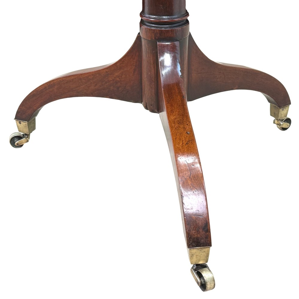 An 18th-century Georgian mahogany octagonal centre table with inlaid crossbanding, a central pedestal column, and tripod legs on brass castors. View IX