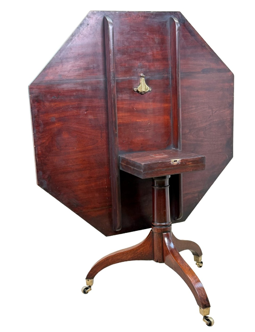 An 18th-century Georgian mahogany octagonal centre table with inlaid crossbanding, a central pedestal column, and tripod legs on brass castors. View XI