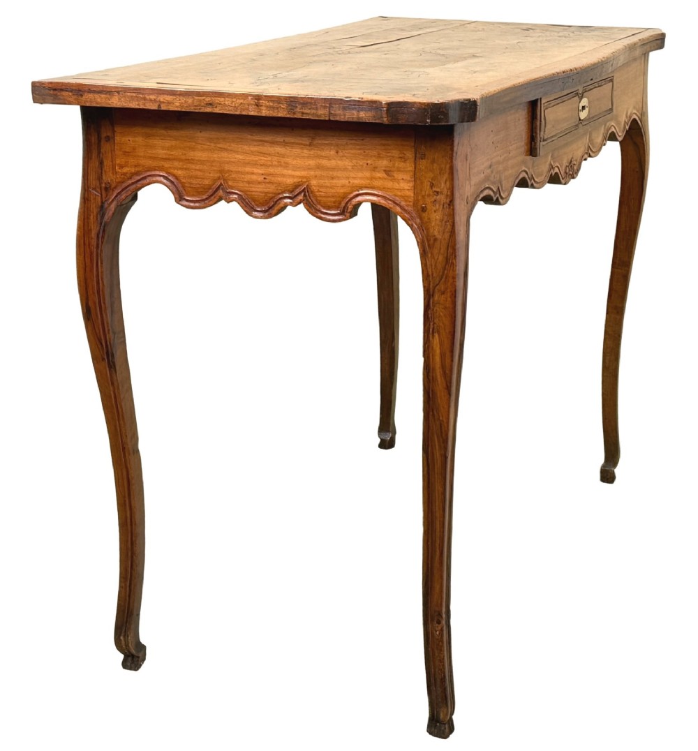 A late 18th-century French Provincial cherry wood side table featuring cabriole legs, a scalloped apron, and a single drawer with a brass escutcheon. View II