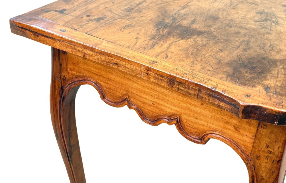 A late 18th-century French Provincial cherry wood side table featuring cabriole legs, a scalloped apron, and a single drawer with a brass escutcheon. View VII