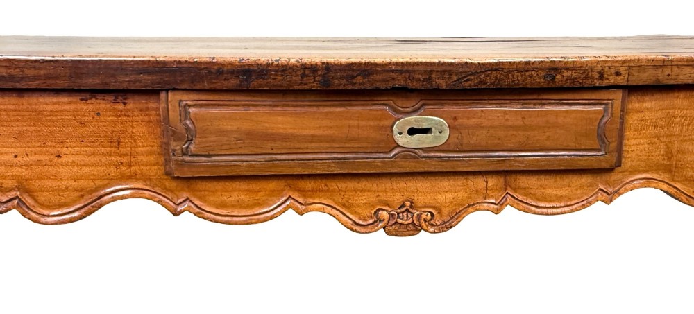 A late 18th-century French Provincial cherry wood side table featuring cabriole legs, a scalloped apron, and a single drawer with a brass escutcheon. View IX