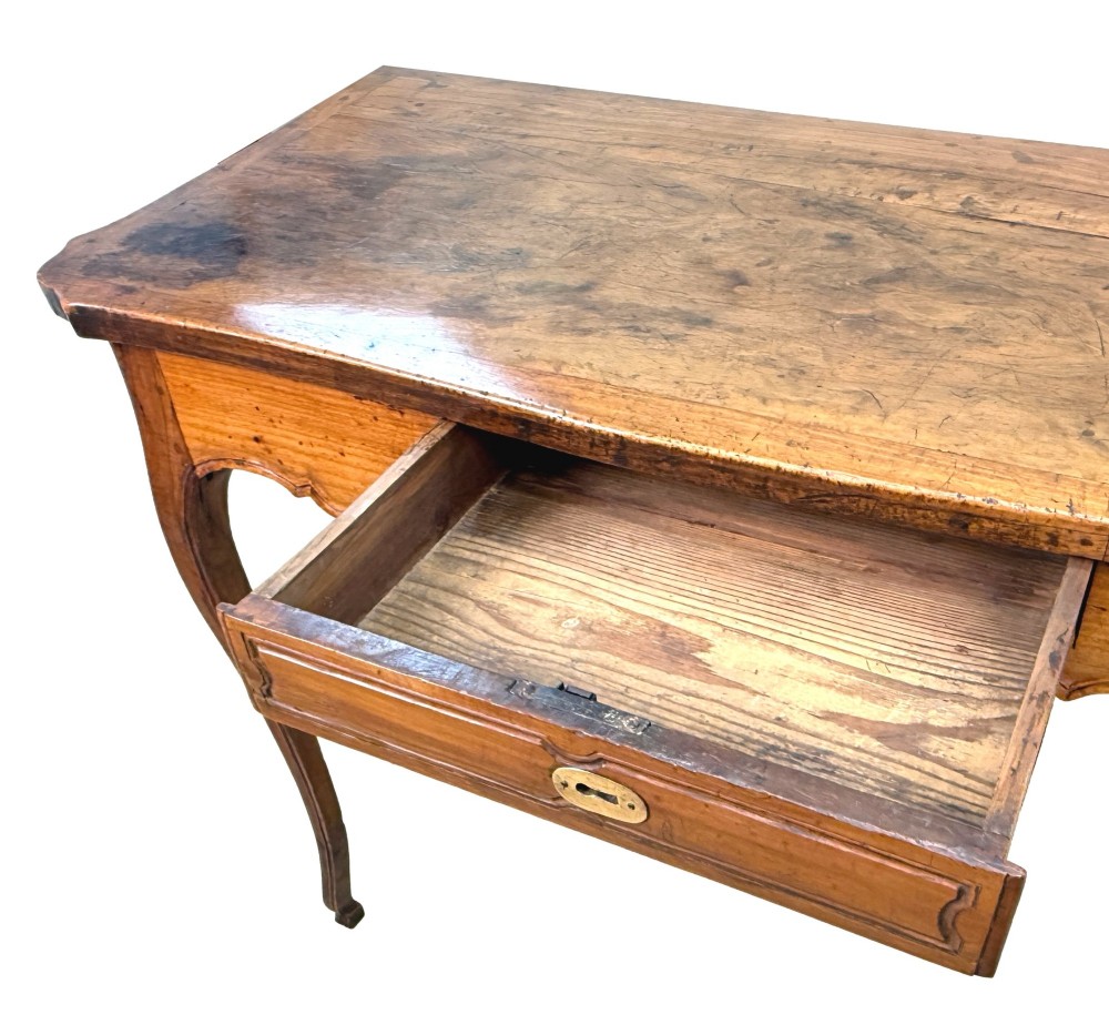 A late 18th-century French Provincial cherry wood side table featuring cabriole legs, a scalloped apron, and a single drawer with a brass escutcheon. View X