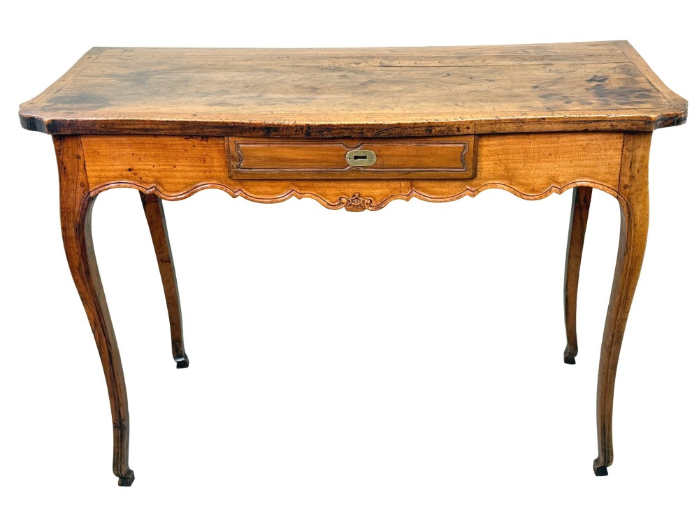 A late 18th-century French Provincial cherry wood side table featuring cabriole legs, a scalloped apron, and a single drawer with a brass escutcheon. View XII